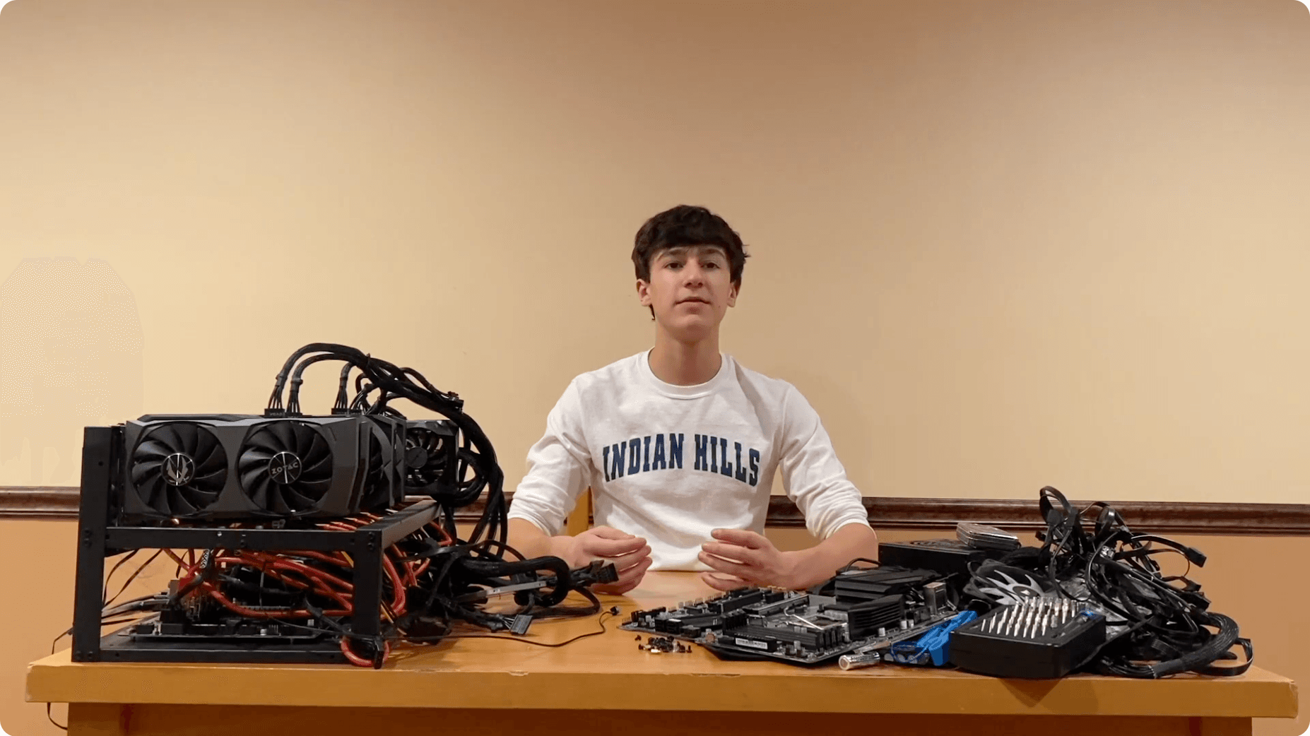 Daniel with Bitcoin mining hardware and GPU components.